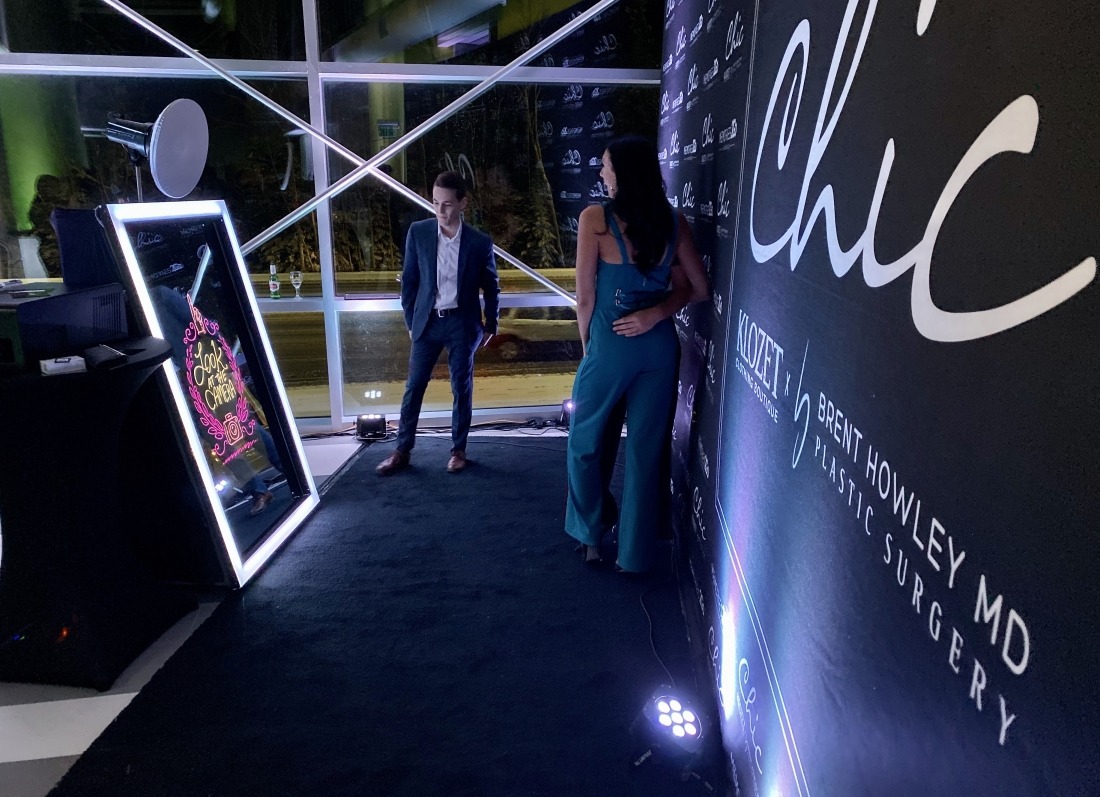 Full-length selfie mirror booth at an evening corporate event